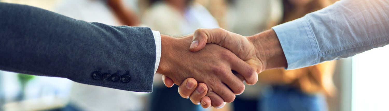 two people shaking hands to begin work on relocating a business
