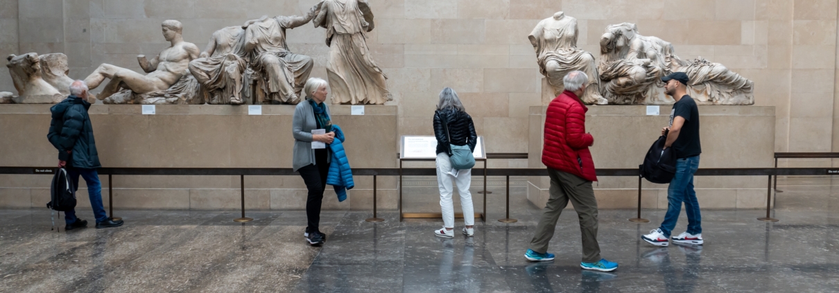 people at a museum looking at sculptures