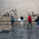 people at a museum looking at sculptures